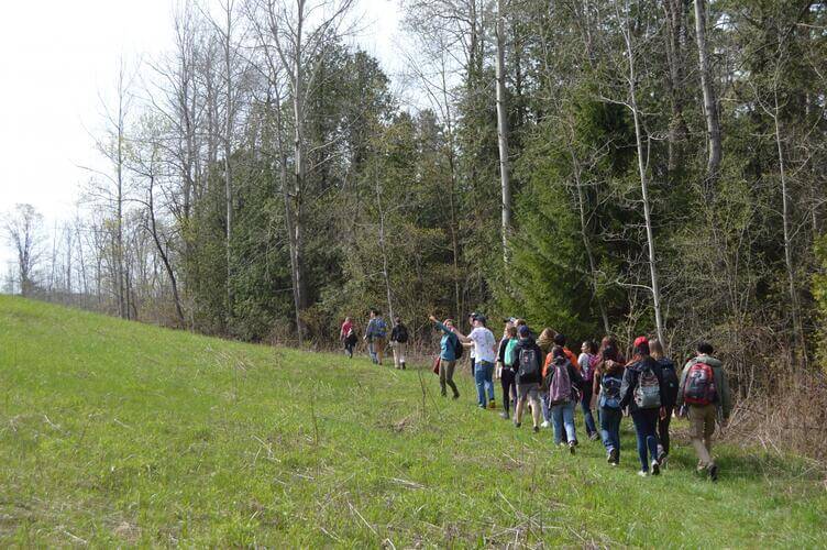 Students walking through woodlot