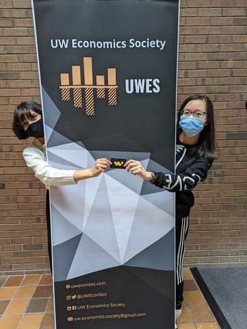 Our Student Outreach Coordinator for Fall 2021, Yana Tiwari, presents Vicky Chen with a W Store gift card