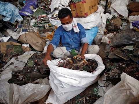 A scrap dealer sorts dismantled TV circuit boards at a scrap yard in Ahmedabad, India, July 2, 2020.
