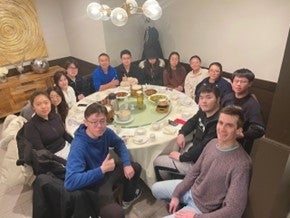students and professors at a restaurant