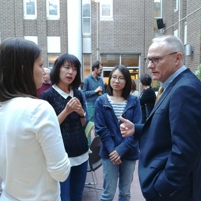 David Card talking to three PhD students