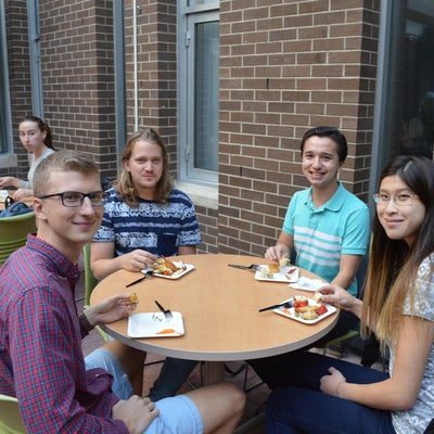 Four students around a table eating