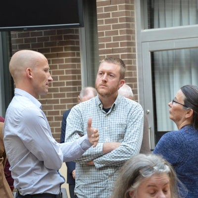 Three faculty members deep in thought with each other