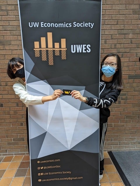 Our Student Outreach Coordinator for Fall 2021, Yana Tiwari, presents Vicky Chen with a W Store gift card