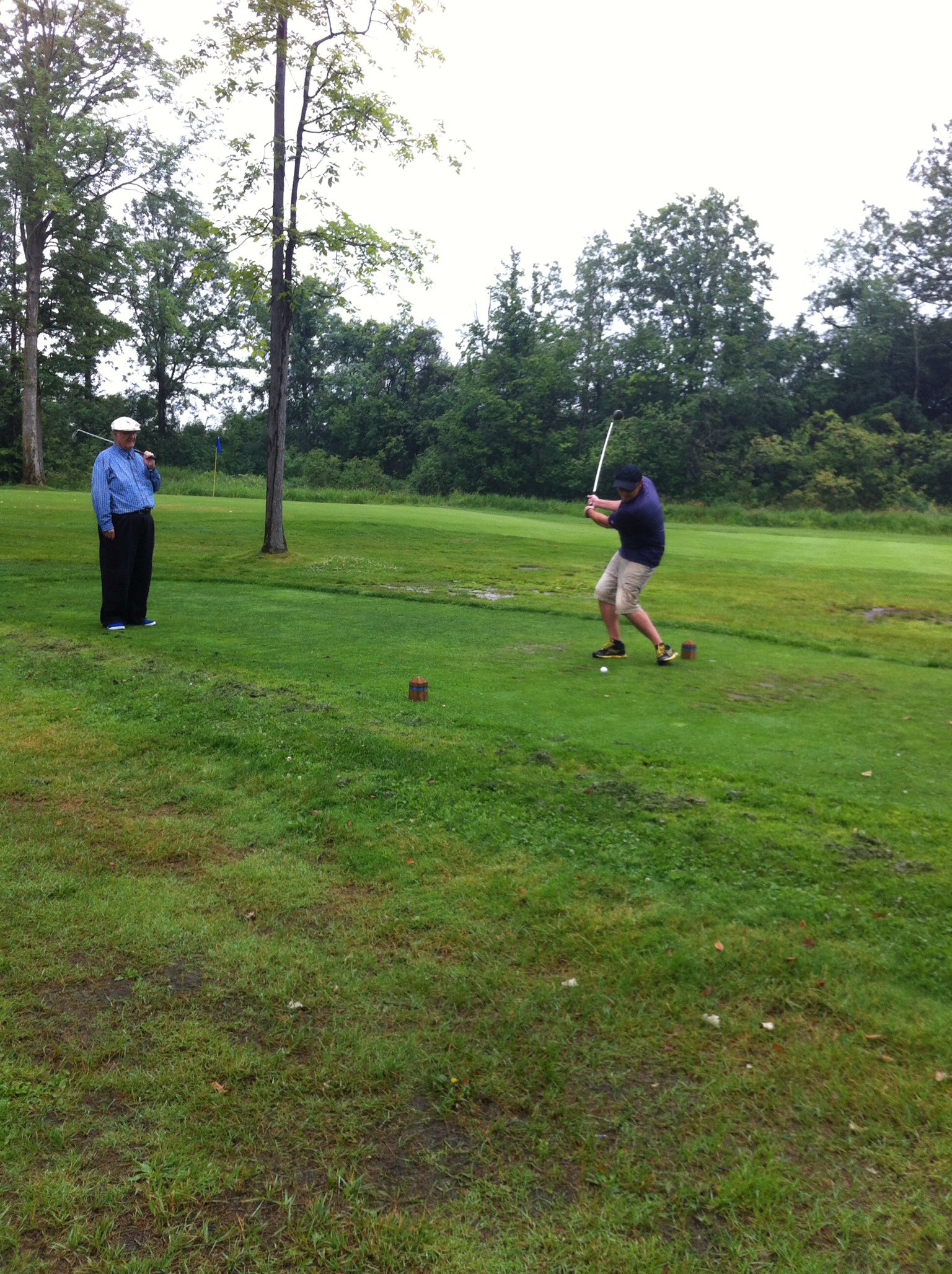Horatio Rus swinging his golf club.