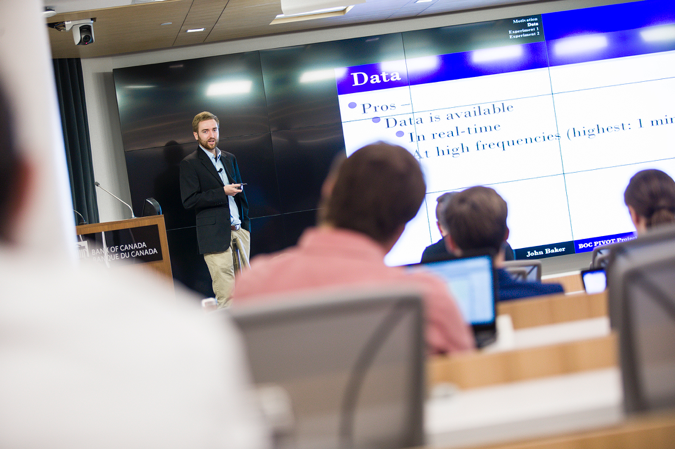 John Baker delivering a presenation to a large group