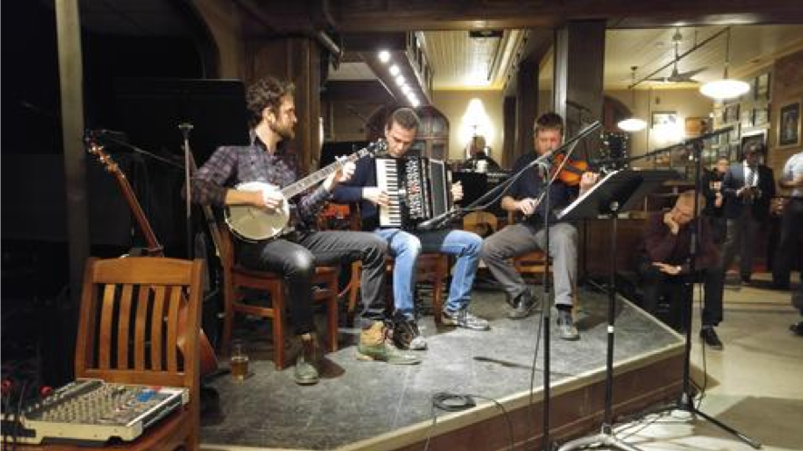 Professors playing performing at Christmas party