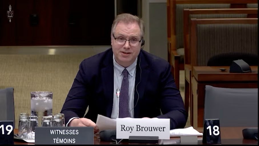 Roy Brouwer sits at a desk in the House of Commons