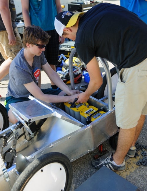 Team placing batteries in their car