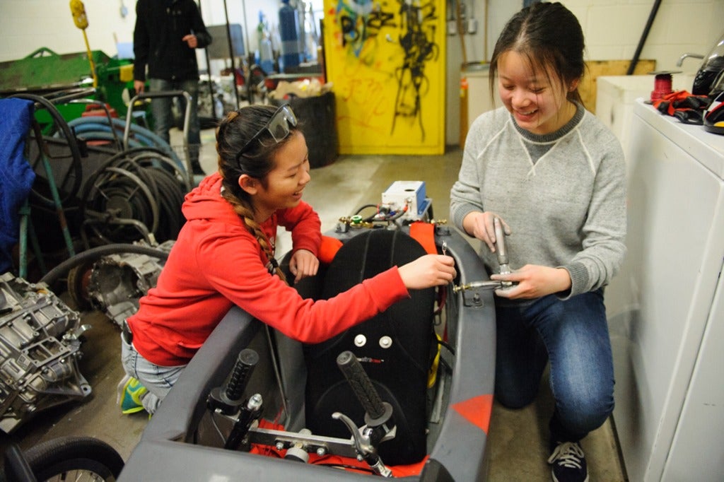 SJAM students Livia and Helen fit the rollbar to car 703