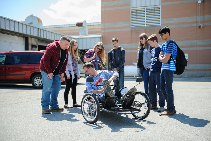 Fit-testing Mr. Ottema in the vehicle