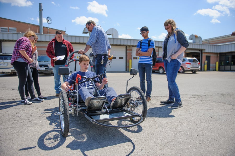 Student sitting in their electric vehicle