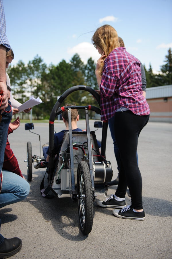 Student sitting in their electric vehicle