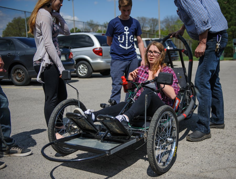 Student sitting in the electric vehicle