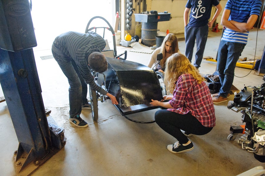 Cowling being placed on the car