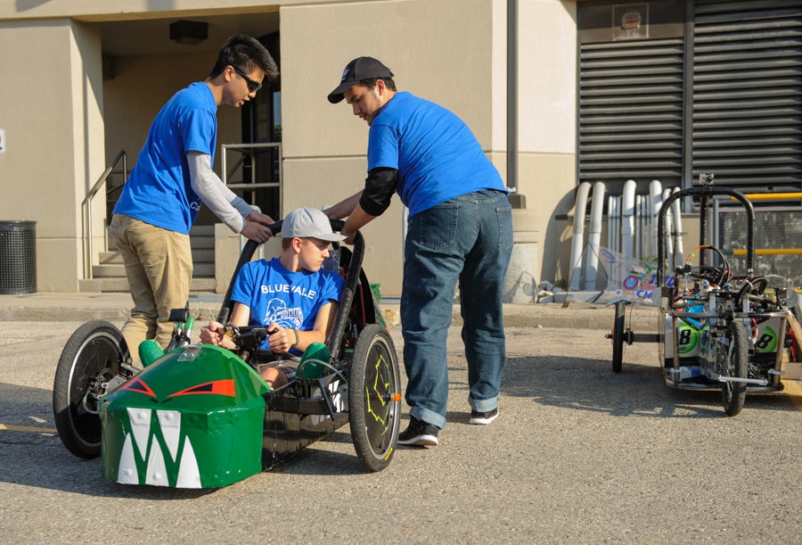 A student sitting in an electric vehicle