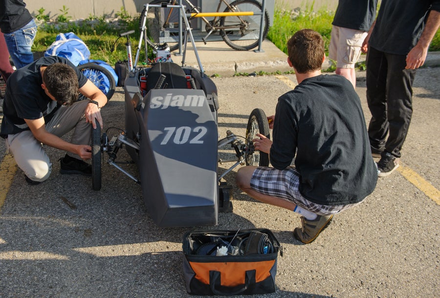 Team members working on their car