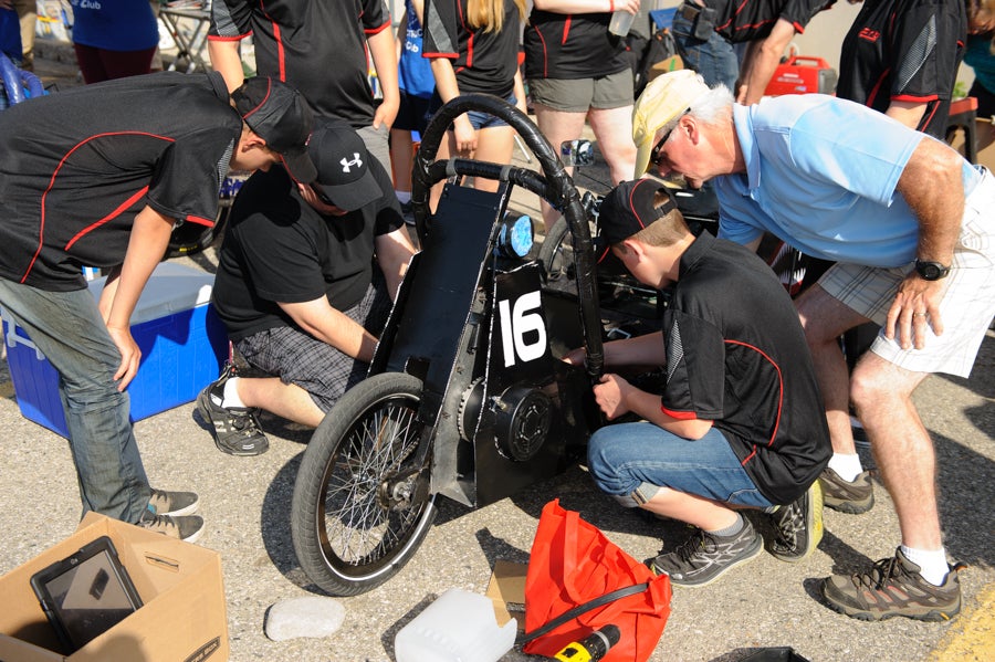 Team making last-minute adjustments to their car