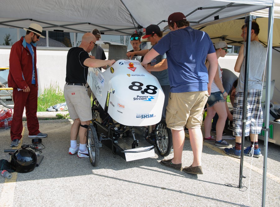 Banting placing their vehicle's shell on their car