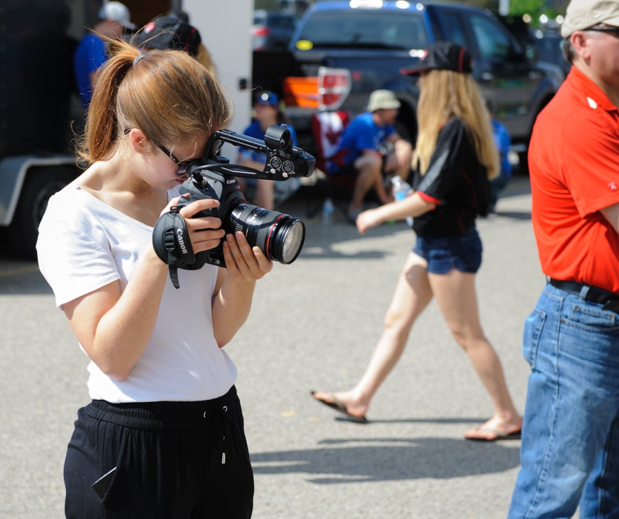 A student holds a camera