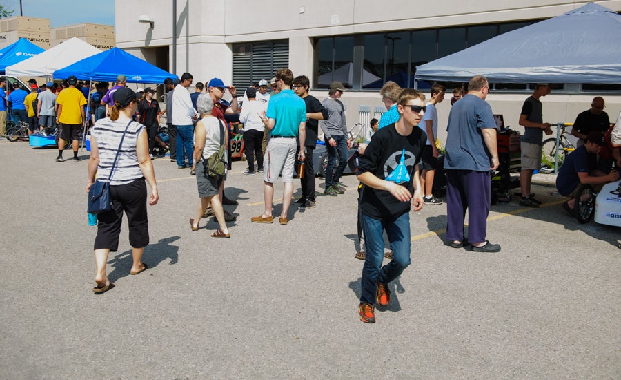 People crowd around the team's tents