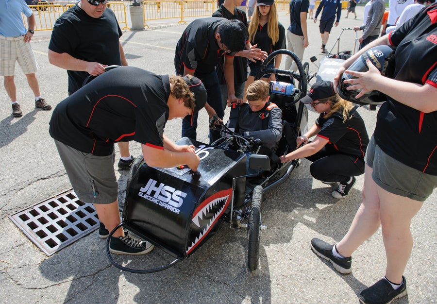 A team member examines the car's transponder