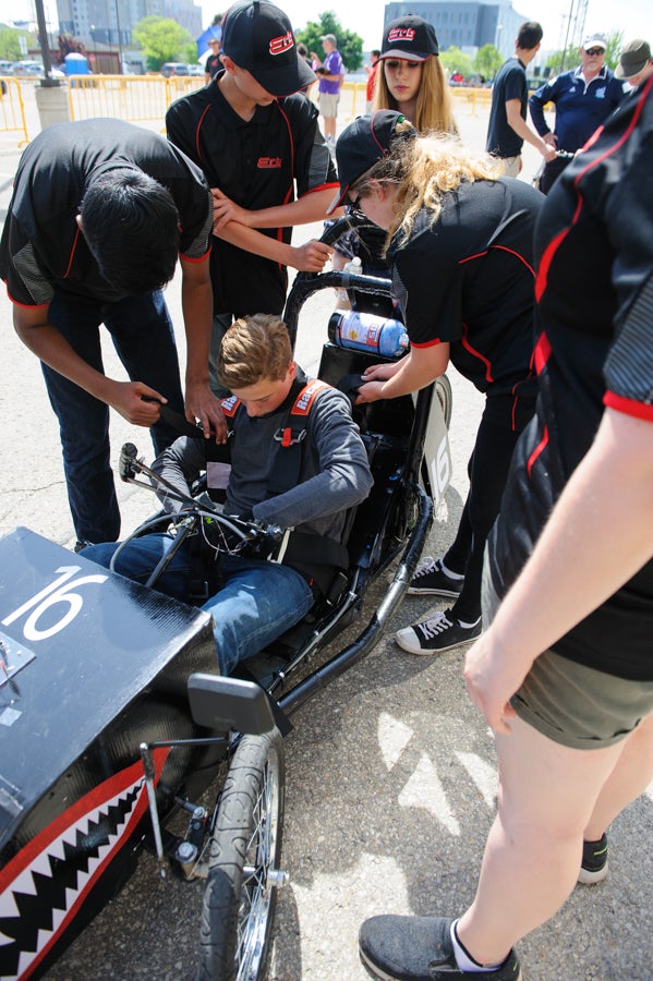 Student is strapped into their car