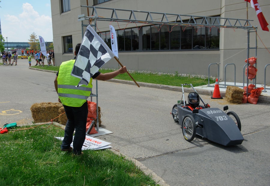 Head marshal waves the checkered flag