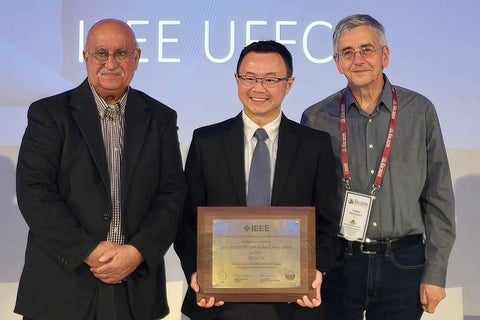 Dr. Alfred Yu (centre) receives the IEEE's 2025 Carl Hellmuth Hertz Award.