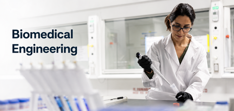 Researcher in a laboratory using a pipette as part of biomedical engineering research.