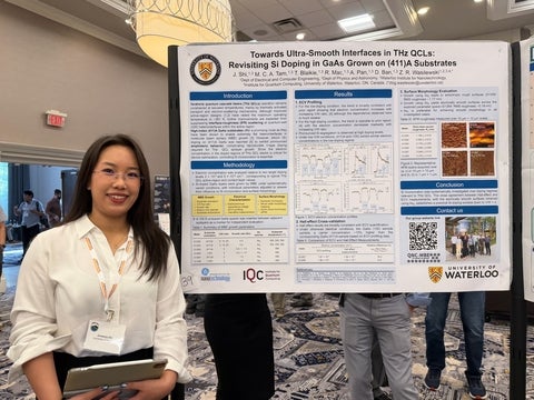 Jinmeng Shi standing with her poster at the conference