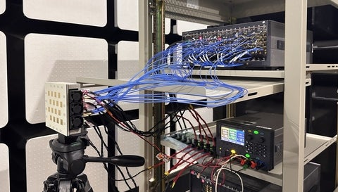 FR3 phased-array front end on a tripod in the anechoic chamber, cabled to a 16-channel signal analyser and bench power supply