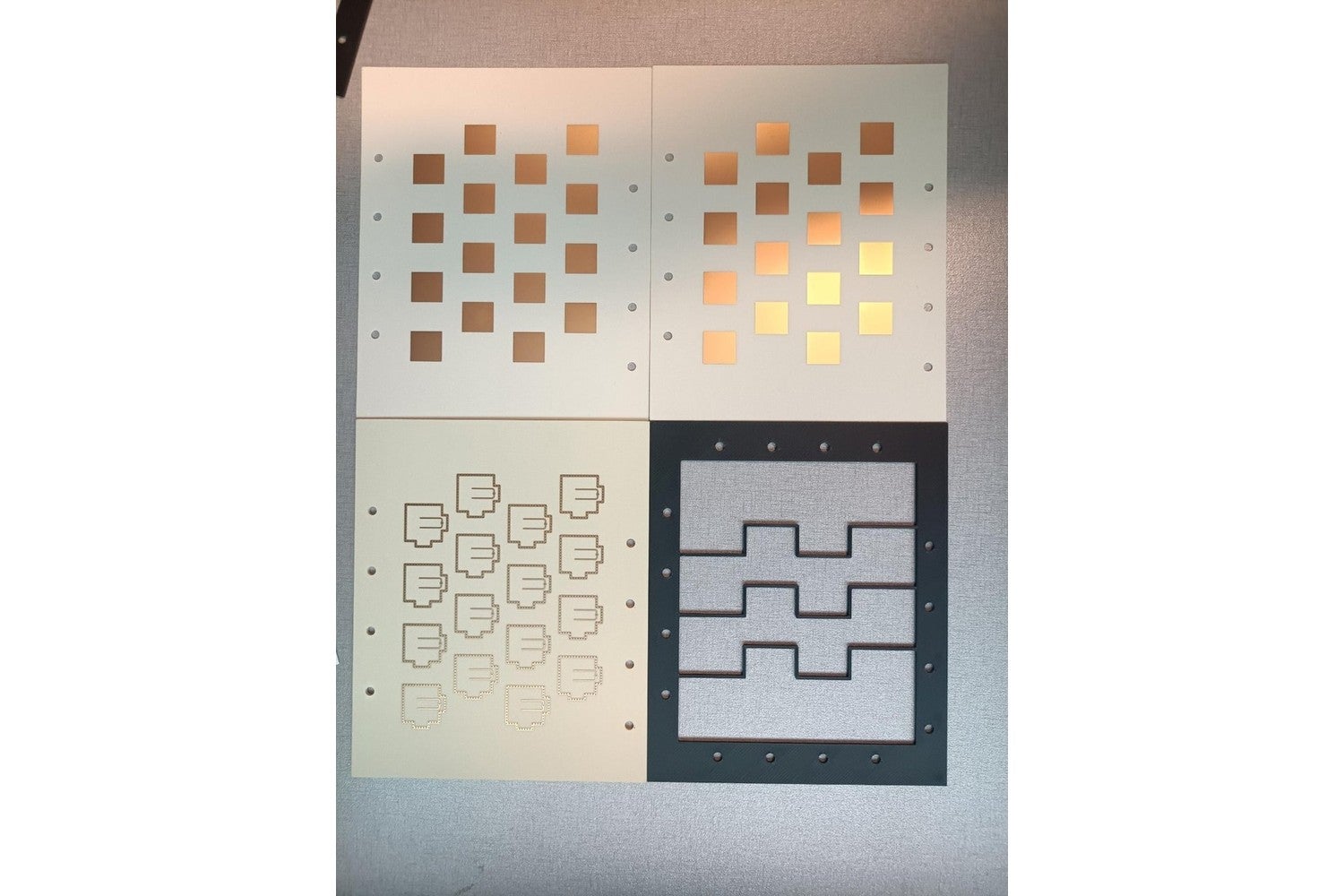 Fabricated FR3 4 by 4 antenna array layers, including the patch array and the coupling apertures