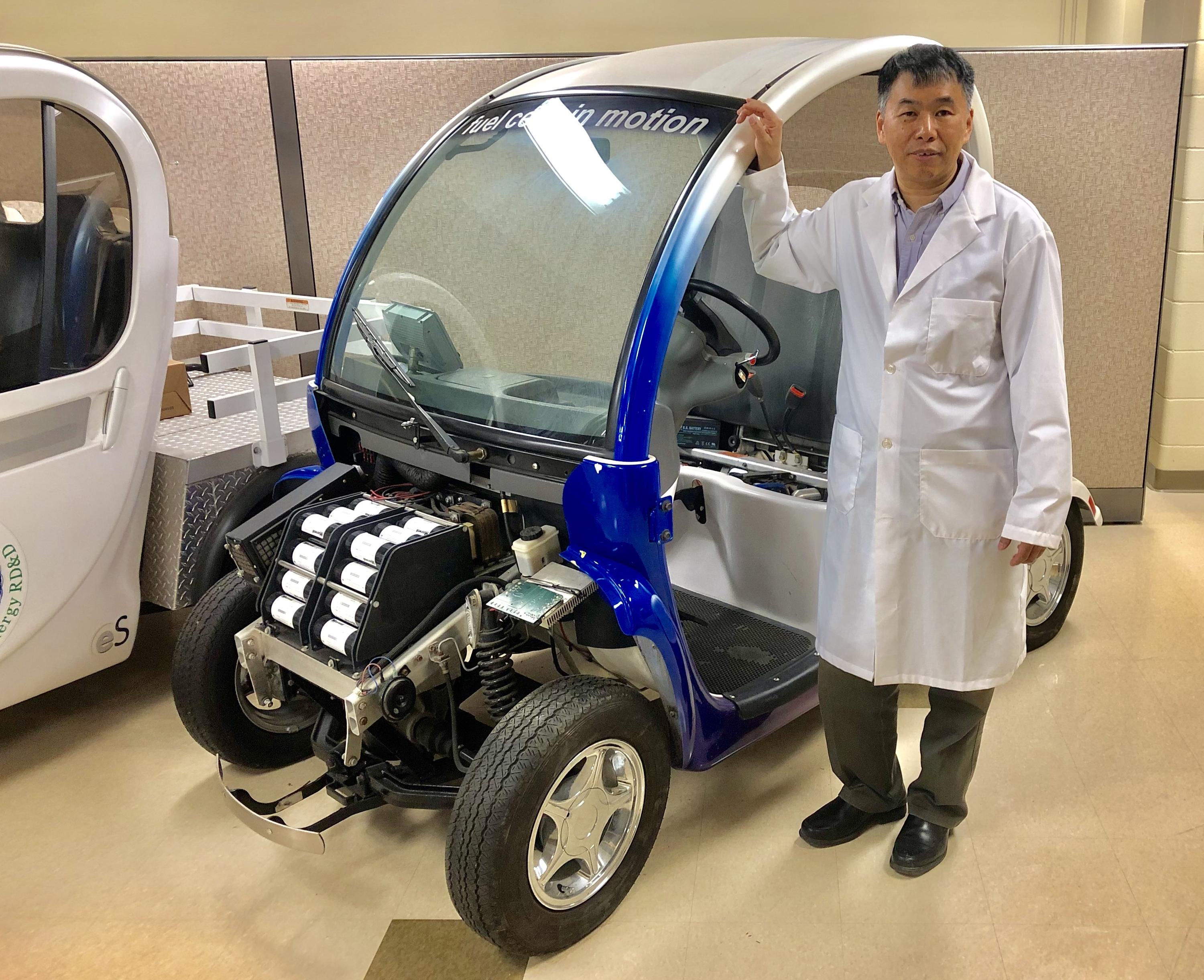 Li, a professor of mechanicaland mechatronics engineering, and director of the lab, pose with a fuel cell test vehicle.