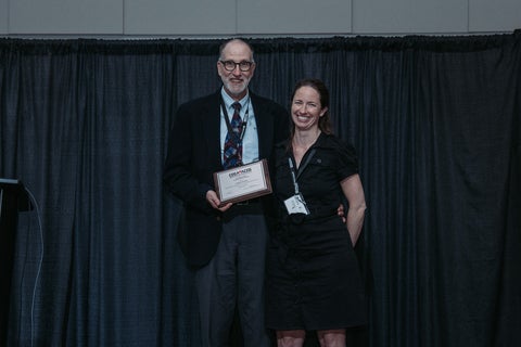 Gordon Stubley and Mary Robinson posing with award