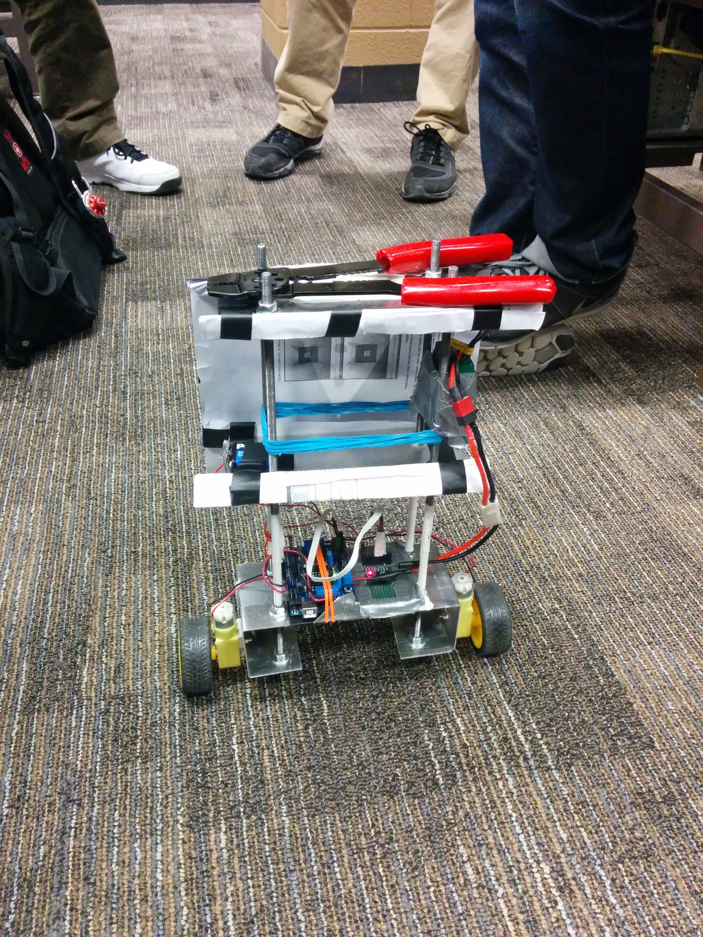 Self-balancing robot run by Arduino holding wire crimpers.
