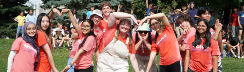 Eight Camp leaders posing to the camera, 4 of which are paired up making a heart shape with their arms