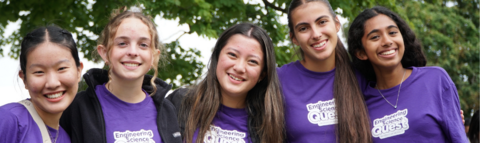 Five female camp leaders smiling to the camera in purple ESQ tshirts