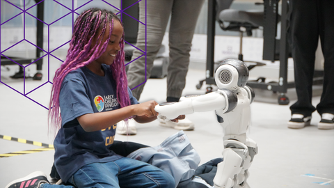 Girl playing with a robot