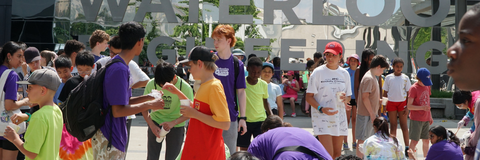 Candid pictures of camper leaders and campers in front of the Waterloo Engineering sign