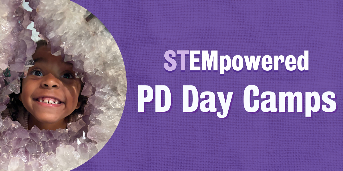 Participant smiling while looking through a gap in a geode