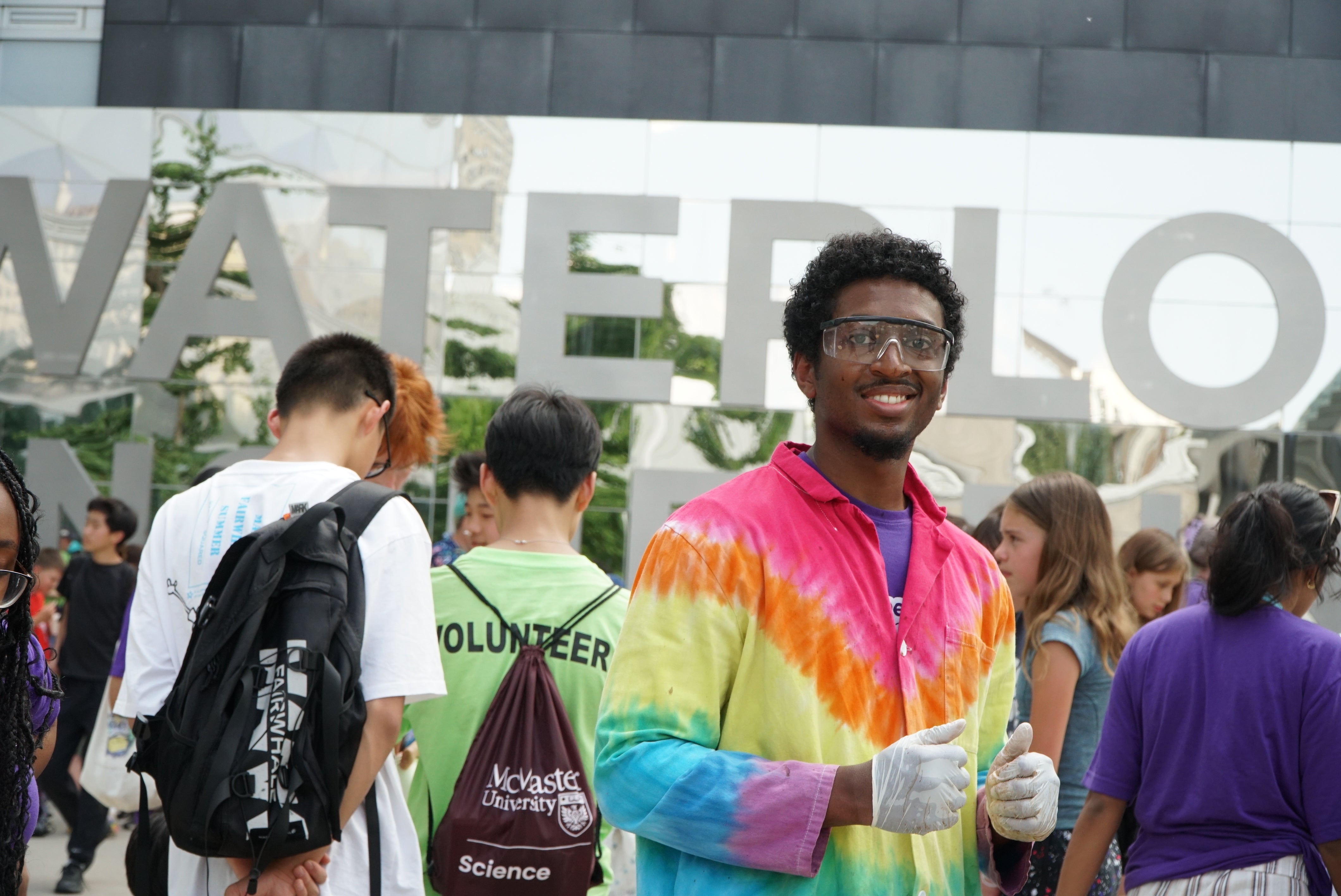 UW volunteer smiling at the camera at an event