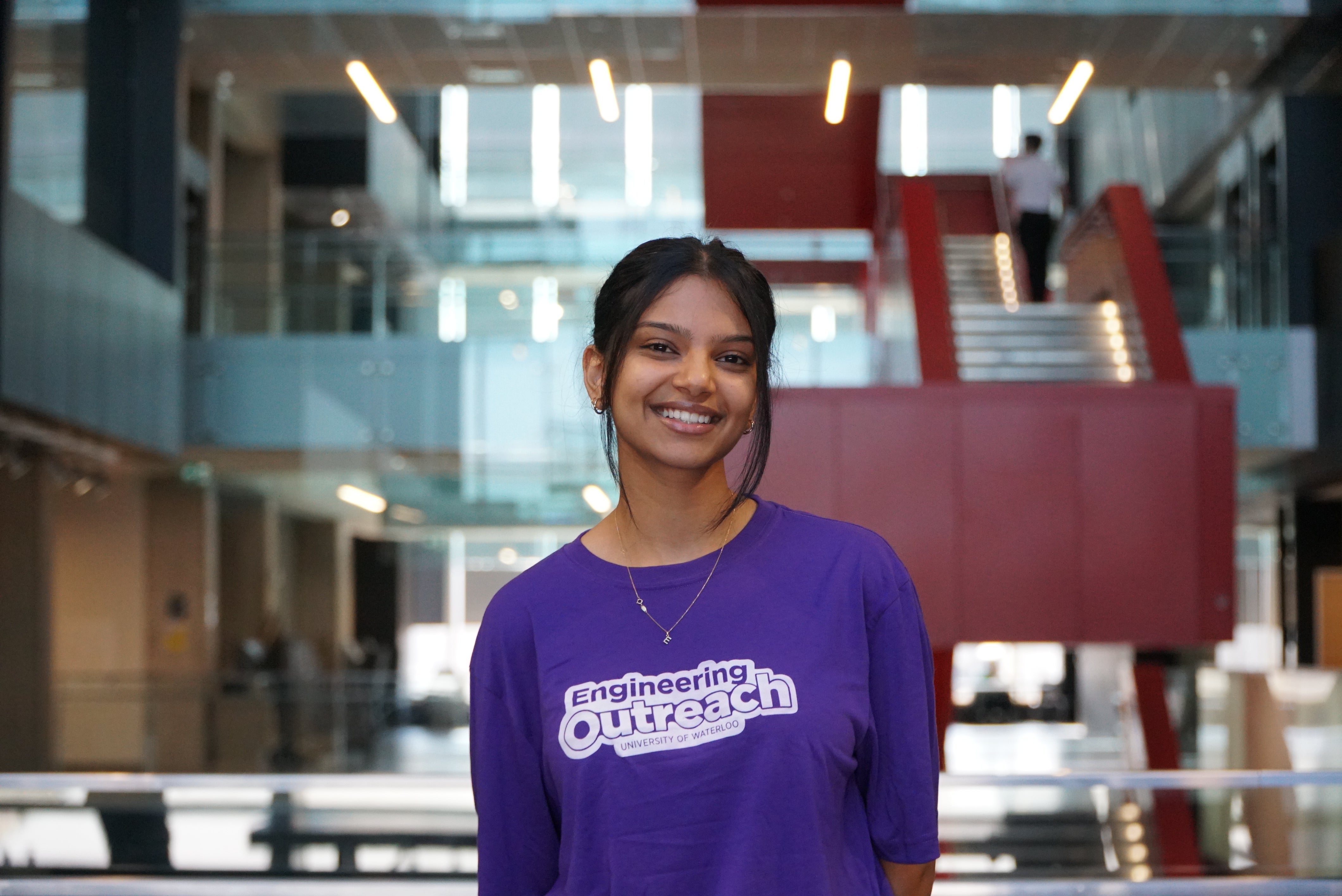 Girl in purple shirt smiling at camera