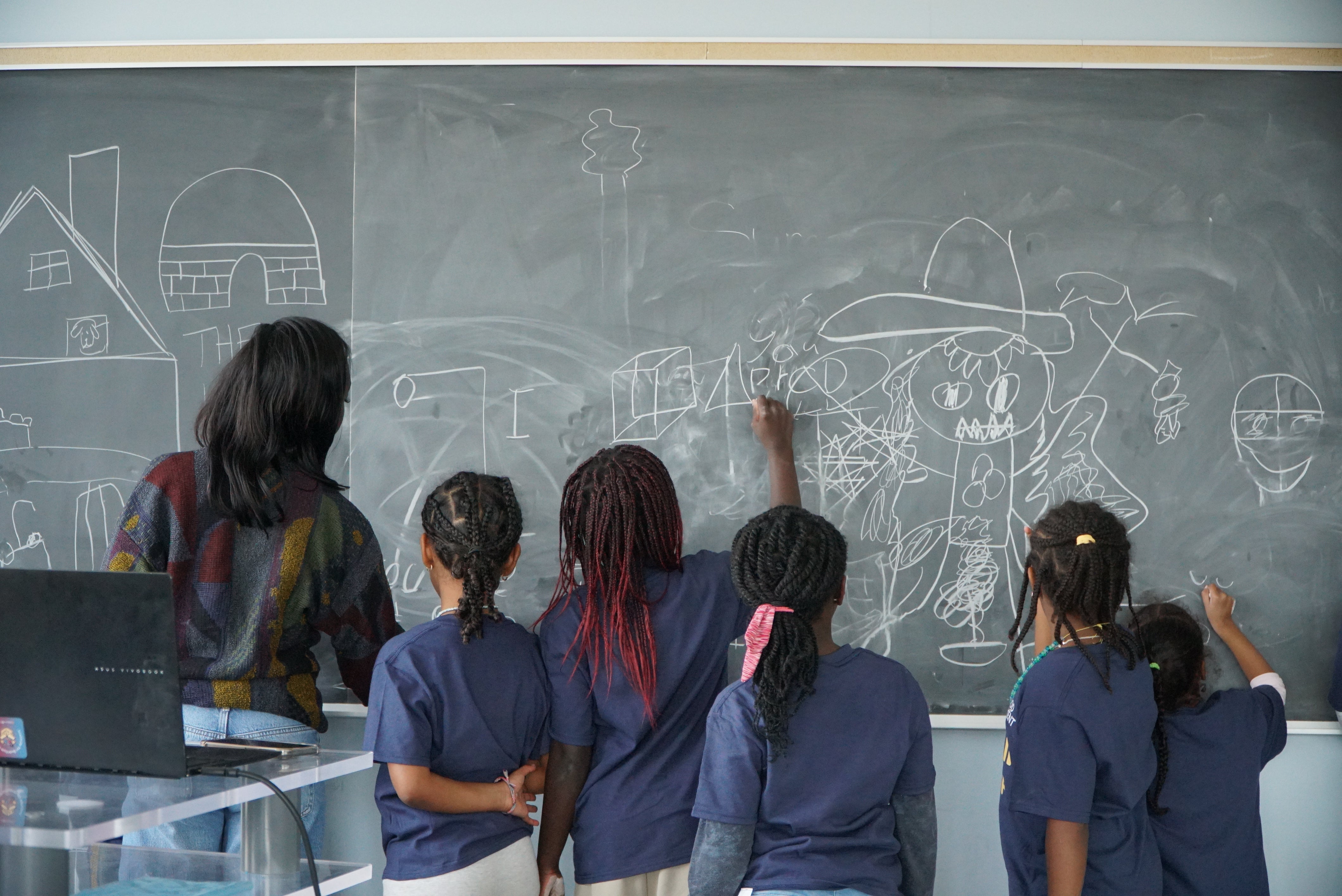 Girls colouring on a chalk board