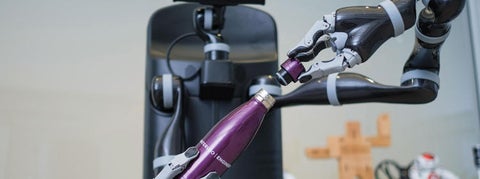 Waterloo Engineering water bottle being opened by a robot