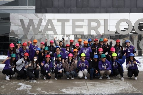 Group of ambassadors in hard hats standing in front of Waterloo Engineering sign