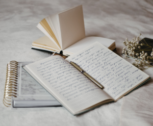 open notebooks lying on a bed