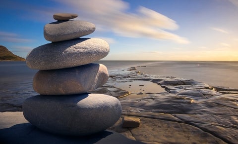pile of rocks beside a beach