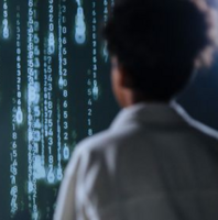 person looking at streams of computer code