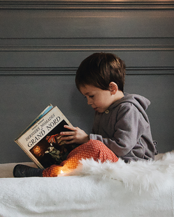 smaller image of child reading book